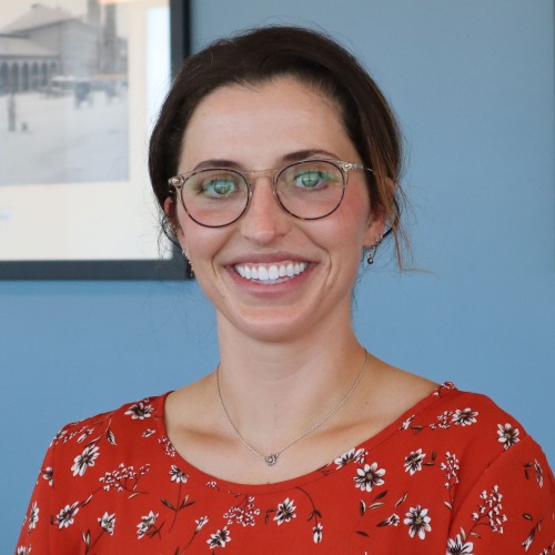 Headshot of Olivia Chaves in front of a blue wall 